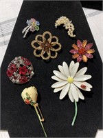 Seven Vintage lapel pins of various colors shapes