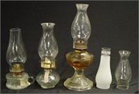 Three clear glass kerosene lamps