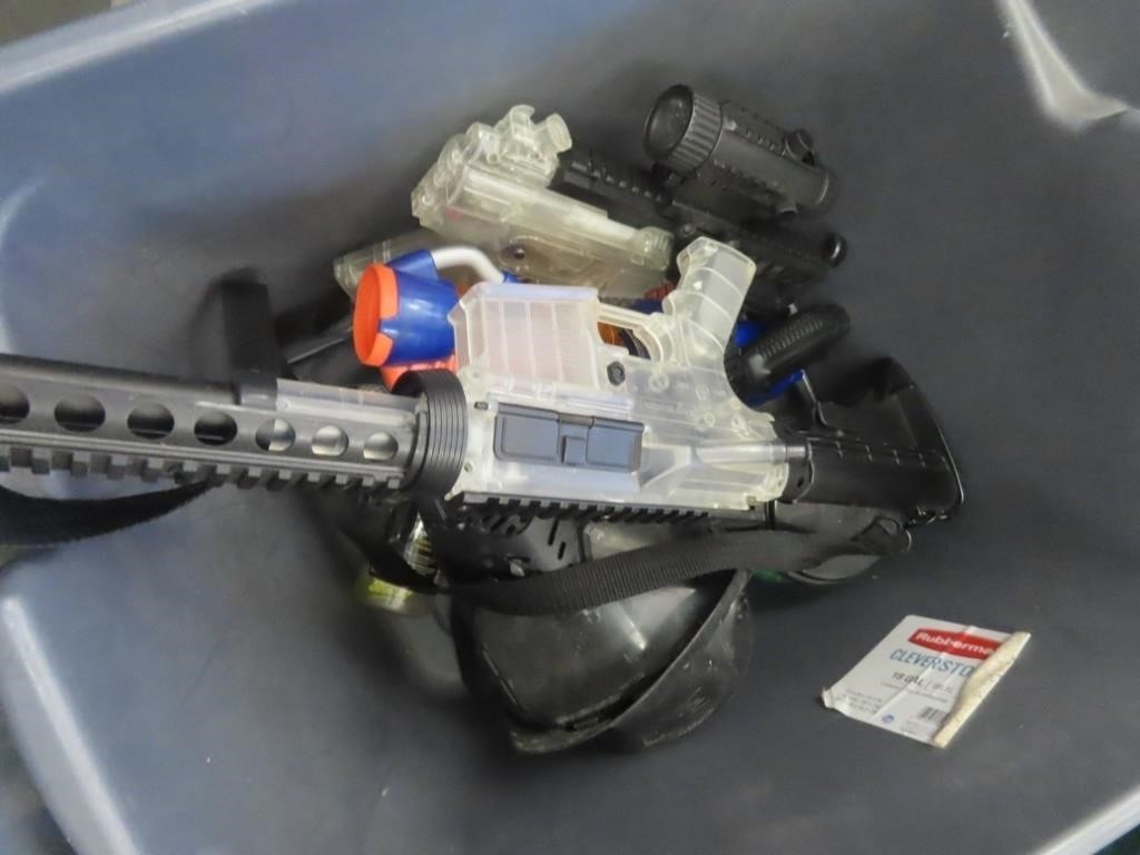 Tote of Plastic shot BB guns & accessories.