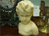 Chalkware bust of a young child.