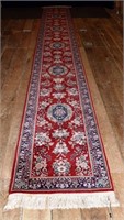 Hand woven oriental corridor carpet with red groun