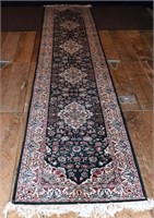 Hand woven oriental corridor carpet with green gro