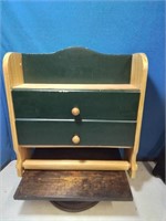 Wooden green and natural cabinet with paper