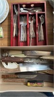 Group of kitchen knives and silverware