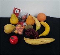 Artificial fruit and an apple tin candle