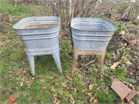 Two galvanized laundry tubs on stands.