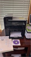 Cannon Imageclass printer with paper and wooden