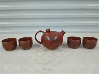 Clay teapot and four cups