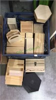 Blue crate filled with wood boxes, all unpainted,
