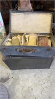 Two vintage suitcases, one small, one filled with