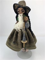 Peruvian woman with alpaca, drop spindle, yarn