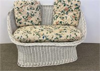 White wicker settee with removable cushions