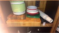 Shelf lot of cutting boards and plates