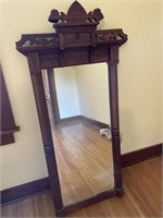 Walnut parlor mirror ornately carved The mirror