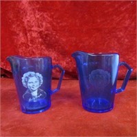 (2)Shirley Temple blue glass small pitchers.