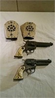 Two Texan cap guns with holsters
