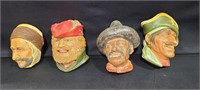 Four Chalkware character heads, some chipping