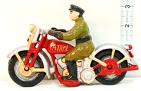 Cast iron man on red Patrol motorcycle