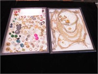 Two containers of costume jewelry, one
