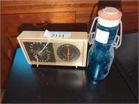 Vintage barometer and blue glass bottle