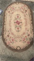 Medium oval hooked rug, browns and reds, measures