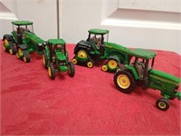 Four John Deere display tractors