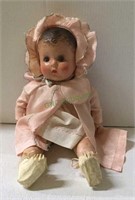 Antique doll in original clothing in sitting
