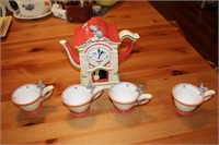 Mouse ran up the clock tea set