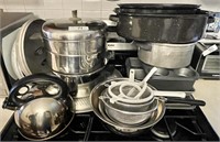 All on top of stove --strainers, teakettle,