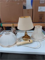 Two lamps, three lamp shades, and power strip
