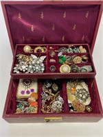 Vintage jewelry box with brooches and rings