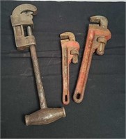 Two pipe wrenches and a pipe cutter