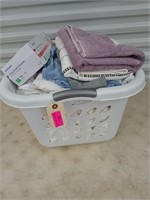 Laundry basket of assorted blankets, sheets,