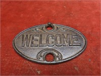 Oval cast iron Welcome sign.