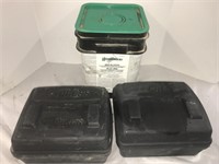 Two pest control bait boxes and a partial pail of