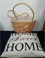 A wicker purse and throw pillow