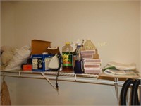 Contents of shelf, ironing board, irons, Tobi