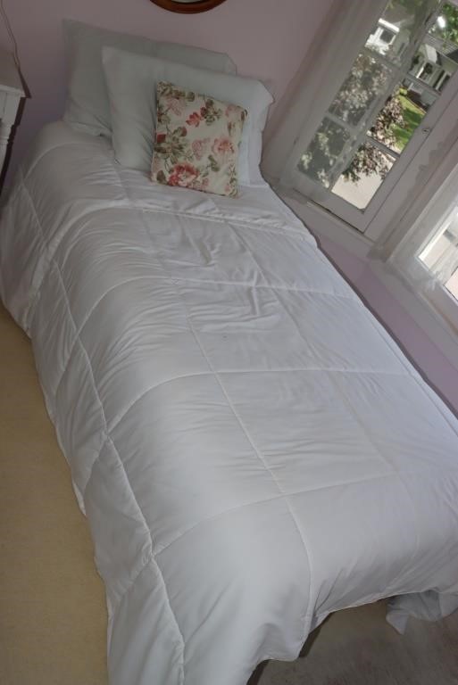 Twin size bed with linens, beveled glass mirror,