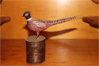 Miniature pheasant carving on wood