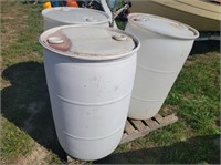 3 white plastic barrels