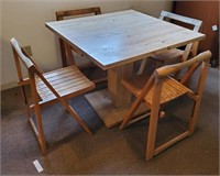 Table and four wooden folding chairs