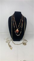 Bag of earth tone colored necklaces