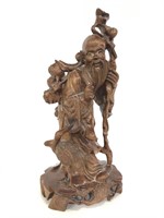 Carved wood Asian man statue