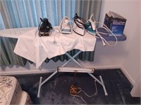 4 clothes irons and ironing board and lamp.
