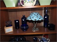 Assorted glassware on shelf.