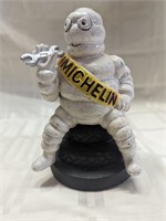 Michelin Man cast iron bank sitting on tires