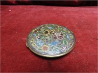 Antique brass enameled makeup compact.