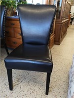 Black leather chair with nailhead accents.
