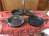 Collection of 4 cast iron pans and 1 glass cover