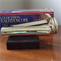 Color Vision kaleidoscope brass sits on wood block